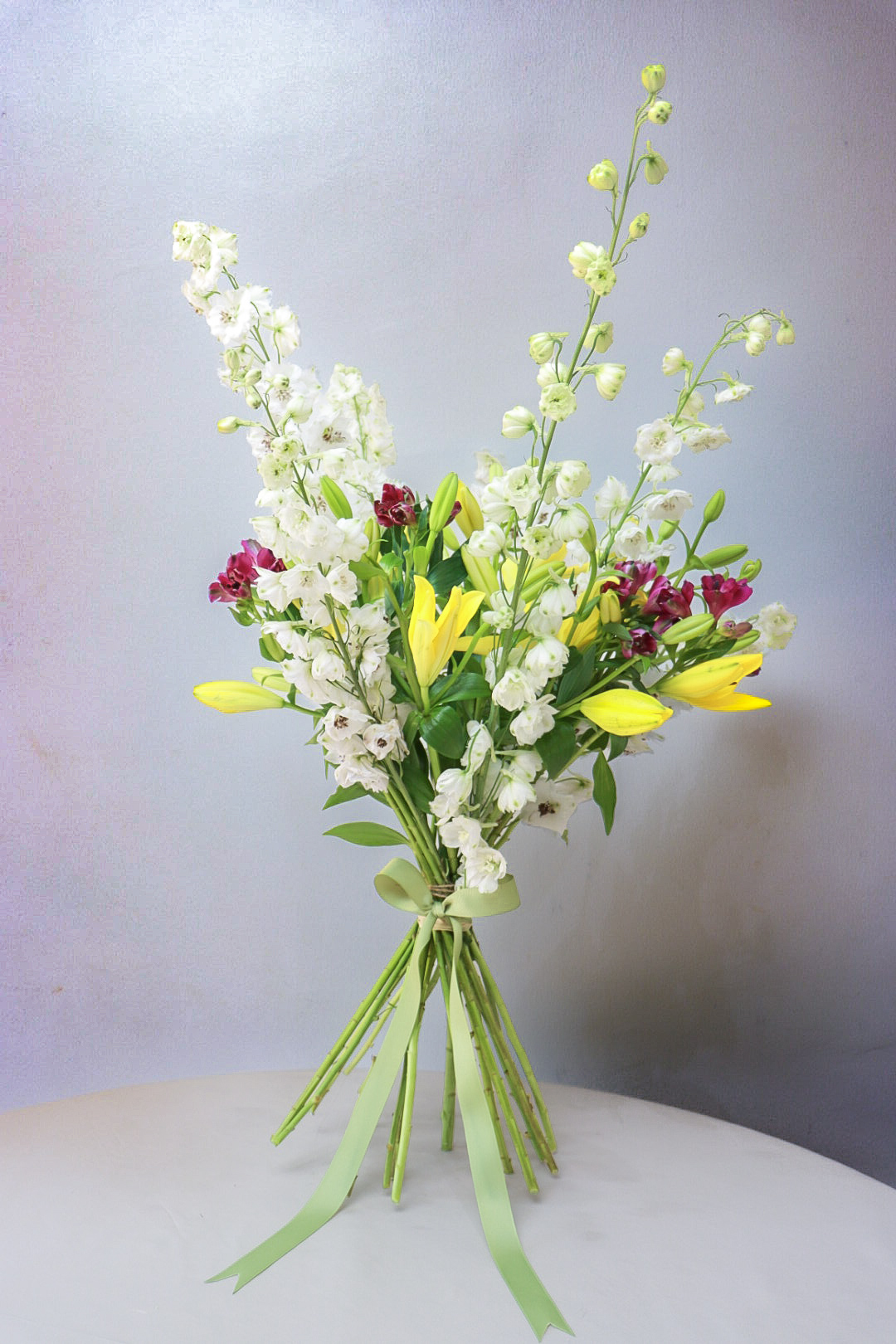 Lavender, pink, and yellow stems with pink ribbon