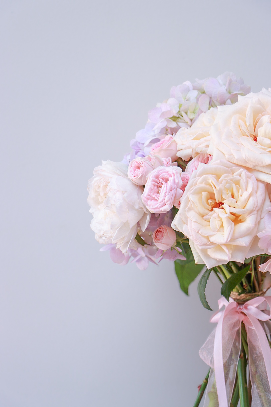 Pastel roses and hydrangeas with soft pink ribbon