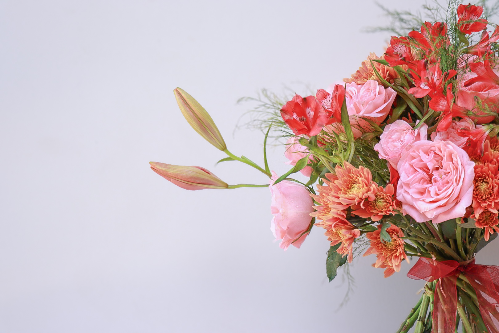 Pink alstroemeria and hydrangeas arranged in a glass vase